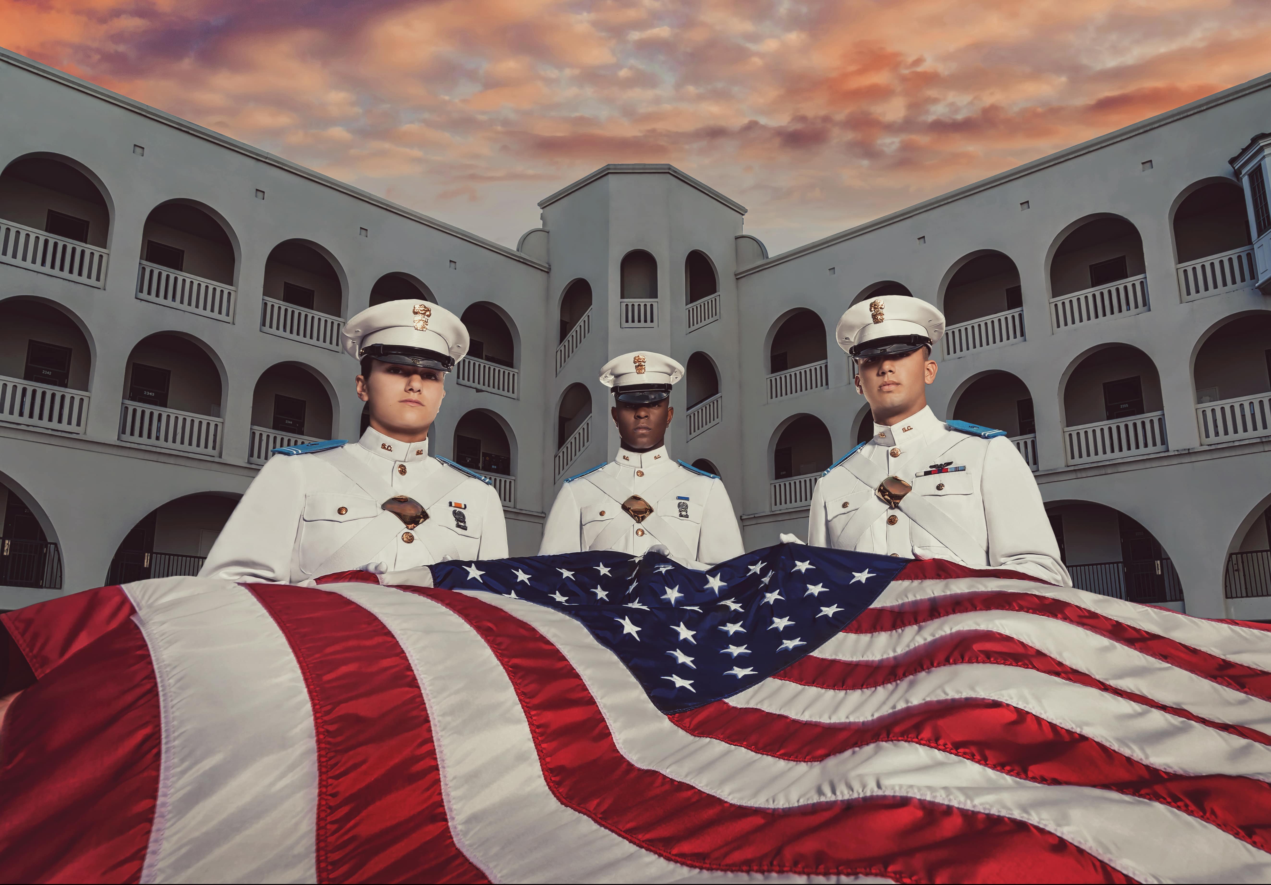 Citadel cadets holding american flag in barracks